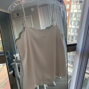 White dressy tank top, scalloped at the hem and neck. Great for work.